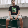 roundneck-tee-mockup-of-a-man-with-dreads-sitting-on-a-bin-22040-min